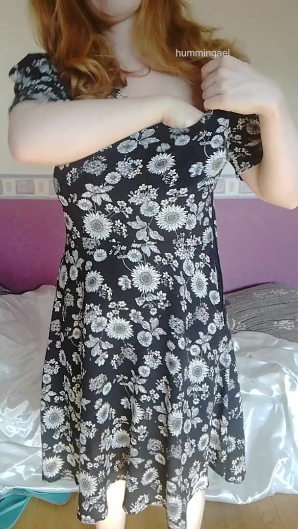 Enjoy a busty redhead struggling to reveal her tits